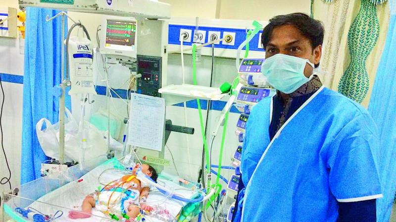 M.S.K Prasad poses beside a baby who got operated on Friday. He pledged to look after her from now on. M.S.K Prasad poses beside a baby who got operated on Friday. He pledged to look after her from now on.