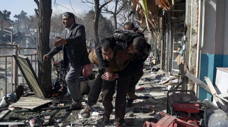 Near the blast site civilians walked through debris-covered streets carrying wounded on their backs as others loaded several bodies at a time into ambulances and private cars to take them to medical facilities around the city. (Photo: AFP) Near the blast site civilians walked through debris-covered streets carrying wounded on their backs as others loaded several bodies at a time into ambulances and private cars to take them to medical facilities around the city. (Photo: AFP)