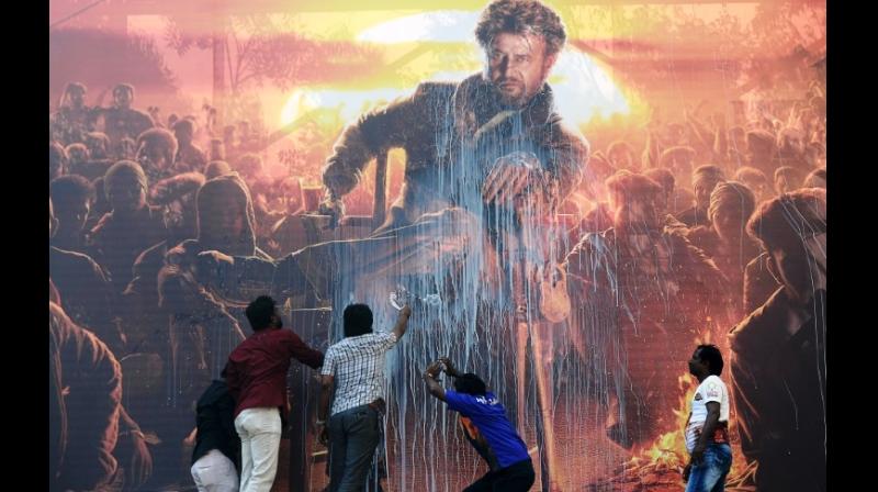 Indian film fans often spray milk on billboards of movie posters depicting their idols to bless new releases. (Photo: AFP) Indian film fans often spray milk on billboards of movie posters depicting their idols to bless new releases. (Photo: AFP)