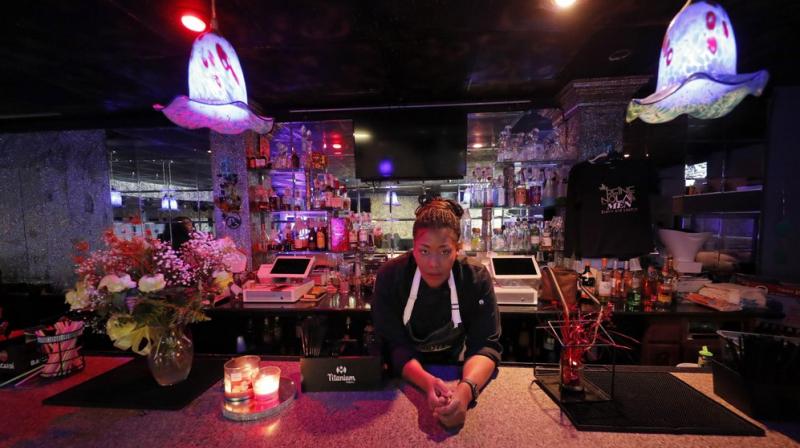 Keisha Henry poses for a portrait inside her lounge and catering business in New Orleans. She lost about $10,000 in revenue last week after three big functions she was slated to cater ended up canceling. Henry said she regrettably had to lay off several employees. (AP Photo) Keisha Henry poses for a portrait inside her lounge and catering business in New Orleans. She lost about $10,000 in revenue last week after three big functions she was slated to cater ended up canceling. Henry said she regrettably had to lay off several employees. (AP Photo)