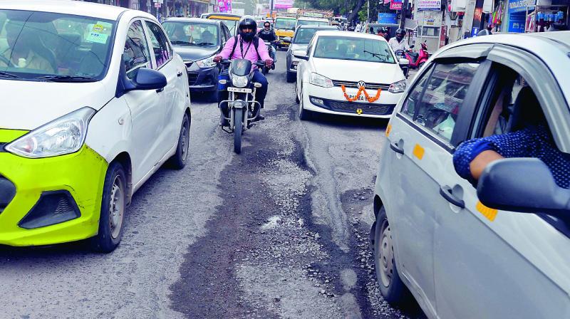 Motorists face difficulties due to damaged roads on the Karimnagar Highway at Karkhana. (Photo: P. Surendra) Motorists face difficulties due to damaged roads on the Karimnagar Highway at Karkhana. (Photo: P. Surendra)
