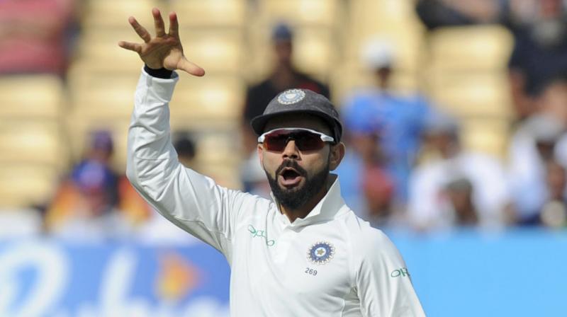 Virat Kohli celebrated the Joe Root dismissal with a 'mic-drop' send-off, something Root had done after guiding England to a 2-1 ODI series win against India last month. (Photo: AP) Virat Kohli celebrated the Joe Root dismissal with a 'mic-drop' send-off, something Root had done after guiding England to a 2-1 ODI series win against India last month. (Photo: AP)
