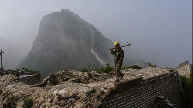 Worker inspects a restored part of the Great Wall in Xiangshuihu in Huairou District. (Photo: AFP) Worker inspects a restored part of the Great Wall in Xiangshuihu in Huairou District. (Photo: AFP)