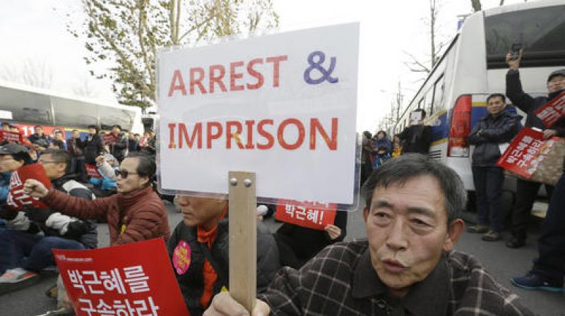 A protester shouts slogans during a rally calling for South Korean President Park Geun-hye to step down near the presidential house in Seoul. (Photo: AP) A protester shouts slogans during a rally calling for South Korean President Park Geun-hye to step down near the presidential house in Seoul. (Photo: AP)