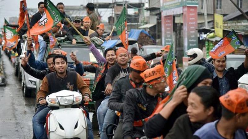 Supporters of BJP celebrate their candidate's win in the Assembly elections in Imphal on Saturday. (Photo: PTI) Supporters of BJP celebrate their candidate's win in the Assembly elections in Imphal on Saturday. (Photo: PTI)