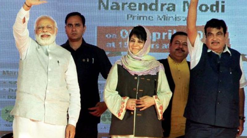 Prime Minister Narendra Modi (L), J&K Chief Minister Mehbooba Mufti (C) and Union Transport Minister Nitin Gadkari at a public rally in Udhampur, Jammu on Sunday. (Photo: PTI) Prime Minister Narendra Modi (L), J&K Chief Minister Mehbooba Mufti (C) and Union Transport Minister Nitin Gadkari at a public rally in Udhampur, Jammu on Sunday. (Photo: PTI)