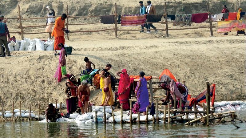 People flock at the river bank People flock at the river bank