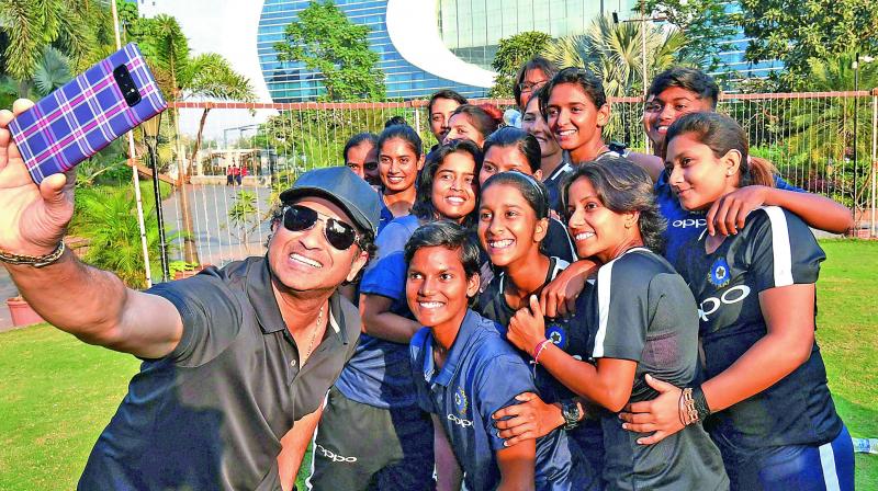 Former Indian batsman Sachin Tendulkar takes a selfie with members of the Indian women’s cricket team at the Bandra Kurla Complex in Mumbai on Monday ahead of the side’s departure to South Africa for a series. (Photo: AP) Former Indian batsman Sachin Tendulkar takes a selfie with members of the Indian women’s cricket team at the Bandra Kurla Complex in Mumbai on Monday ahead of the side’s departure to South Africa for a series. (Photo: AP)