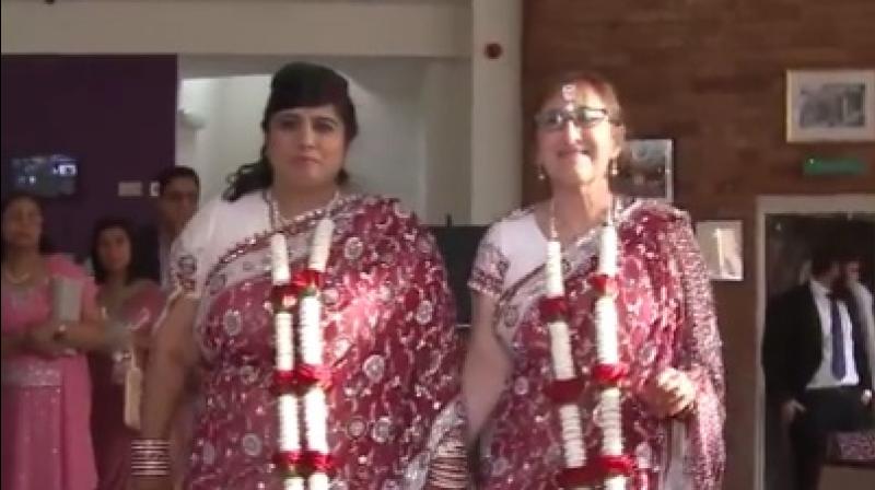 Kalavati and Miriam after their marriage ceremony, dressed in traditional sarees (Photo: Youtube screengrab Pukaar News/ SWNS) Kalavati and Miriam after their marriage ceremony, dressed in traditional sarees (Photo: Youtube screengrab Pukaar News/ SWNS)