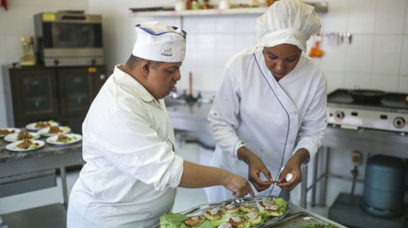 In this Tuesday, Oct. 10, 2017 photo, Khaled Maghary, 25, receives instructions from a trained specialist, as he prepares a dish at a restaurant in Rabat, Morocco. (Photo: AP) In this Tuesday, Oct. 10, 2017 photo, Khaled Maghary, 25, receives instructions from a trained specialist, as he prepares a dish at a restaurant in Rabat, Morocco. (Photo: AP)