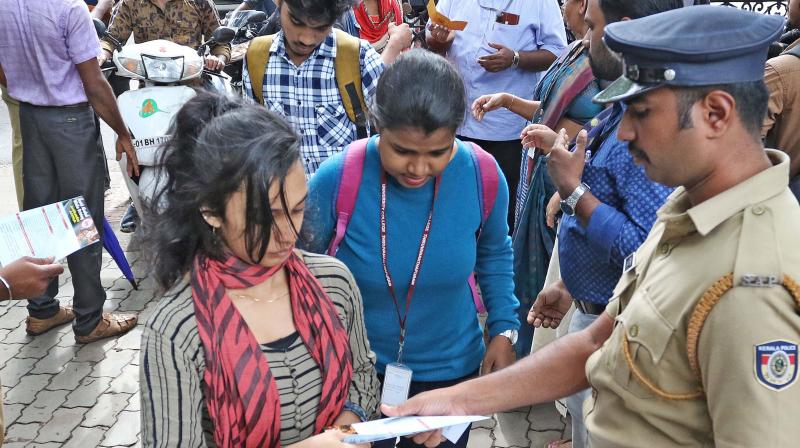 Police personnel check the ID cards of the students of University College, Thiruvananthapuram, after the institution reopened on Monday. (Photo: DC) Police personnel check the ID cards of the students of University College, Thiruvananthapuram, after the institution reopened on Monday. (Photo: DC)