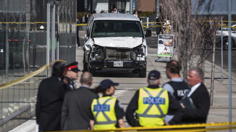 Police seen near a damaged van after a van mounted a sidewalk crashing into pedestrians in Toronto on Monday. (Photo: AP) Police seen near a damaged van after a van mounted a sidewalk crashing into pedestrians in Toronto on Monday. (Photo: AP)