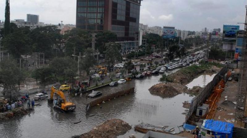 Vehicles plying at a flooded road following heavy rains, in Hyderabad. (Photo: PTI) Vehicles plying at a flooded road following heavy rains, in Hyderabad. (Photo: PTI)