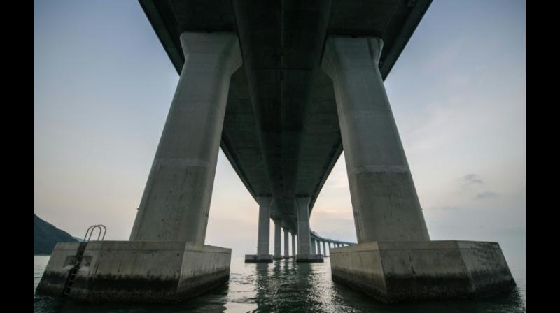 The 55-kilometer crossing, which includes a snaking road bridge and underwater tunnel, links Hong Kong's Lantau island to Zhuhai and the gambling enclave of Macau, across the waters of the Pearl River Estuary. (Photo: AFP) The 55-kilometer crossing, which includes a snaking road bridge and underwater tunnel, links Hong Kong's Lantau island to Zhuhai and the gambling enclave of Macau, across the waters of the Pearl River Estuary. (Photo: AFP)