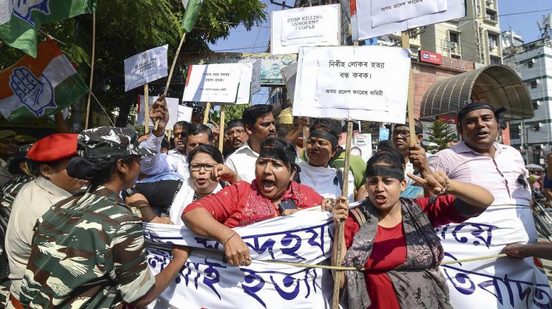 Assam Pradesh Congress Committee (APCC) activists take part in a protest against the killing of innocent people in Tinsukia District of Assam on Friday evening, in front of Rajiv Bhawan in Guwahati. (Photo: PTI) Assam Pradesh Congress Committee (APCC) activists take part in a protest against the killing of innocent people in Tinsukia District of Assam on Friday evening, in front of Rajiv Bhawan in Guwahati. (Photo: PTI)
