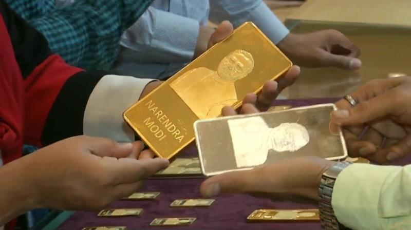 A jewellery shop in Surat has attracted customers by selling gold and silver bars with imprints of PM Modi and former PM late Atal Bihari Vajpayee. (Photo: ANI) A jewellery shop in Surat has attracted customers by selling gold and silver bars with imprints of PM Modi and former PM late Atal Bihari Vajpayee. (Photo: ANI)