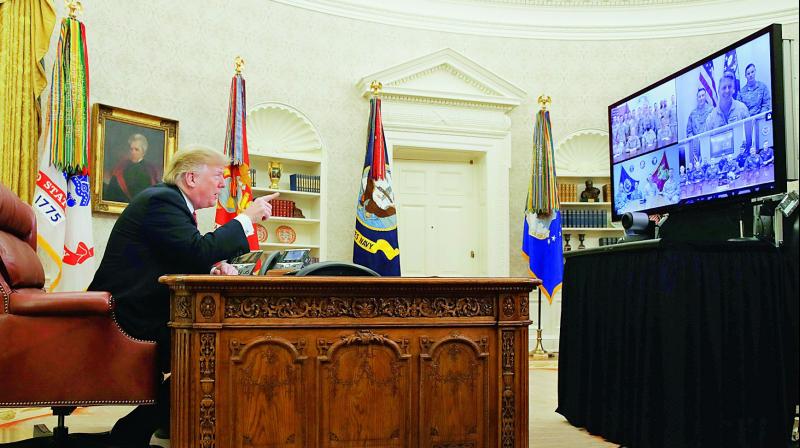 US President Donald Trump speaks with members of the five branches of the military by video conference on Christmas Day on Tuesday, in the Oval Office of the White House. The military members were stationed in Guam, Qatar, Alaska, and two groups in Bahrain. — AP US President Donald Trump speaks with members of the five branches of the military by video conference on Christmas Day on Tuesday, in the Oval Office of the White House. The military members were stationed in Guam, Qatar, Alaska, and two groups in Bahrain. — AP