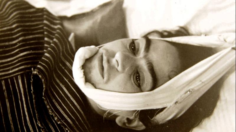 This 1940 photo provided by Sotheby's shows artist Frida Kahlo with her head suspended by straps, is a part of the photographs by Nicholas Muray up for auction. (Photo: AP) This 1940 photo provided by Sotheby's shows artist Frida Kahlo with her head suspended by straps, is a part of the photographs by Nicholas Muray up for auction. (Photo: AP)