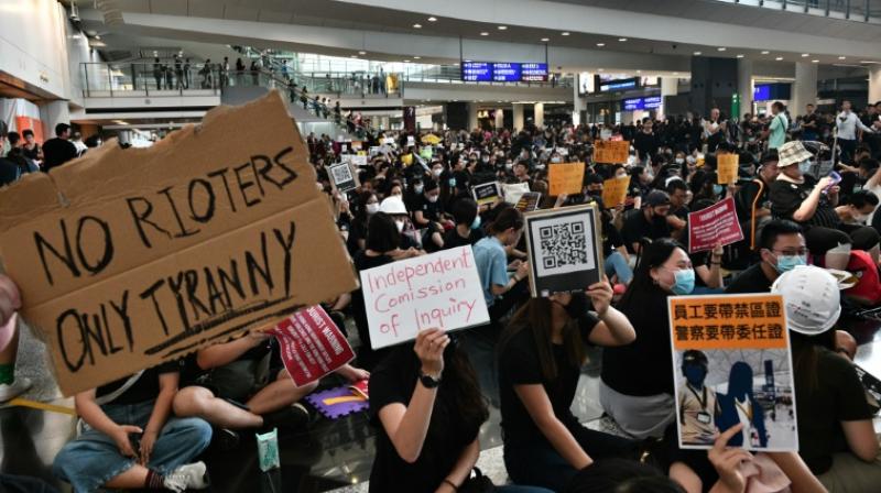 On Friday visitors were greeted by a sea of black-clad protesters chanting anti-government slogans, holding banners and handing out flyers. (Photo: AFP) On Friday visitors were greeted by a sea of black-clad protesters chanting anti-government slogans, holding banners and handing out flyers. (Photo: AFP)