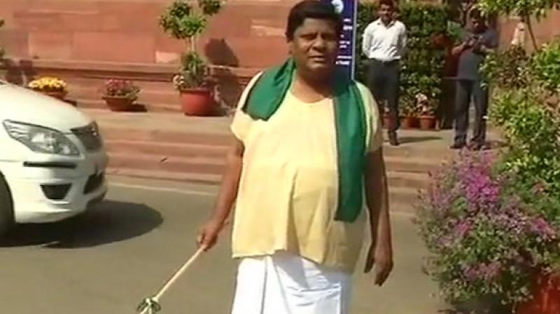 Telugu Desam Party (TDP) MP Naramalli Sivaprasad on Friday sported the look of cattle herder to protest against the denial of special category status to Andhra Pradesh, at the Parliament premises. (Photo: ANI) Telugu Desam Party (TDP) MP Naramalli Sivaprasad on Friday sported the look of cattle herder to protest against the denial of special category status to Andhra Pradesh, at the Parliament premises. (Photo: ANI)