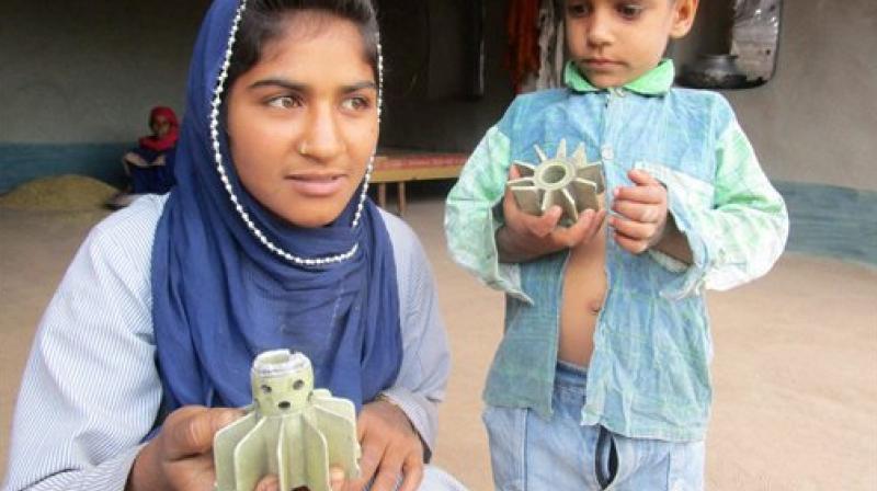 Children showing remains of mortar shells fired from across the LOC by Pakistan in village Panjgrain, Rajouri district. (Photo: PTI) Children showing remains of mortar shells fired from across the LOC by Pakistan in village Panjgrain, Rajouri district. (Photo: PTI)