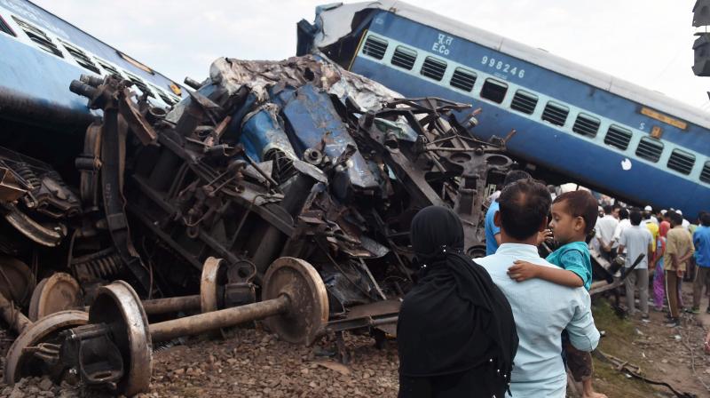 People looking at the wreckage of the rail compartments as workers are carrying out the repair work after Puri-Haridwar Utkal Express derailed in Khatauli near Muzaffarnagar on Saturday. (Photo: PTI) People looking at the wreckage of the rail compartments as workers are carrying out the repair work after Puri-Haridwar Utkal Express derailed in Khatauli near Muzaffarnagar on Saturday. (Photo: PTI)