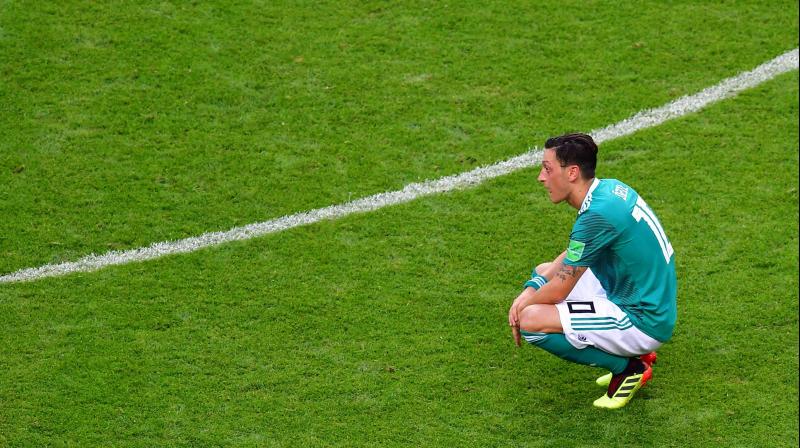 Pressure had already been mounting on the Arsenal midfielder in the World Cup run-up over a controversial photograph with Turkey President Recep Tayyip Erdogan that was seized on to question his loyalty to Germany. (Photo: AFP) Pressure had already been mounting on the Arsenal midfielder in the World Cup run-up over a controversial photograph with Turkey President Recep Tayyip Erdogan that was seized on to question his loyalty to Germany. (Photo: AFP)