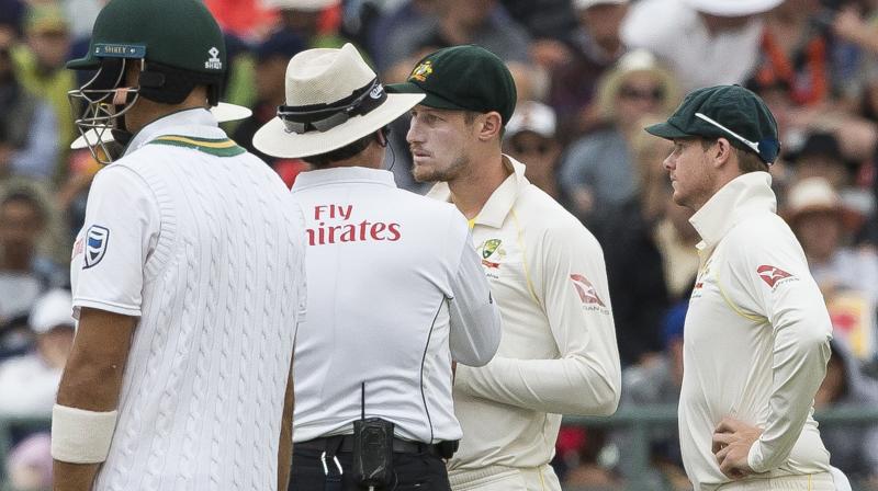 Television footage had showed Smith's teammate Cameron Bancroft, 25, taking a yellow object out of his pocket while fielding in the post-lunch session and appearing to rub it on the ball. (Photo: AP) Television footage had showed Smith's teammate Cameron Bancroft, 25, taking a yellow object out of his pocket while fielding in the post-lunch session and appearing to rub it on the ball. (Photo: AP)
