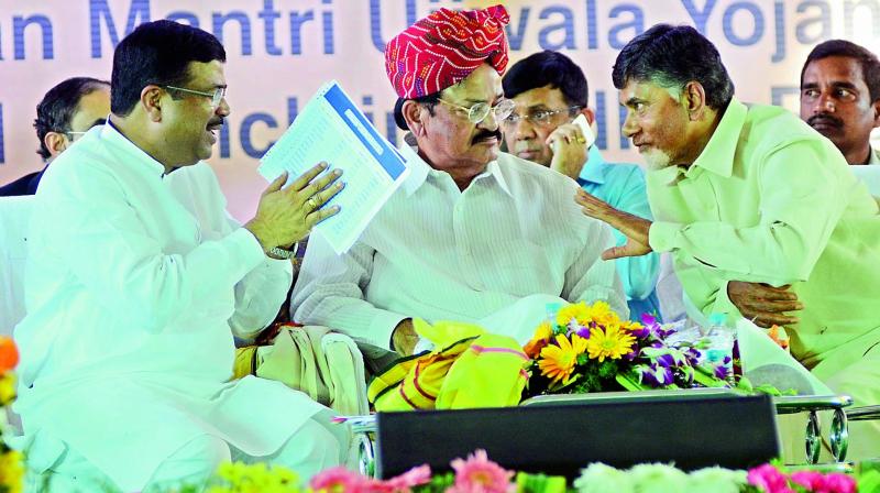 Chief Minister Chandrababu Naidu has a word with minister of state for petroleum Dharmendra Pradhan as Union urban development minister M. Venkaiah Naidu looks on at the foundation stone laying ceremony of IIPE Petroleum University, PM Ujwal Yojana and Dedication of National Skill Development Institute at Sabbavaram in Visakhapatnam district on Thursday. (Photo: DC) Chief Minister Chandrababu Naidu has a word with minister of state for petroleum Dharmendra Pradhan as Union urban development minister M. Venkaiah Naidu looks on at the foundation stone laying ceremony of IIPE Petroleum University, PM Ujwal Yojana and Dedication of National Skill Development Institute at Sabbavaram in Visakhapatnam district on Thursday. (Photo: DC)