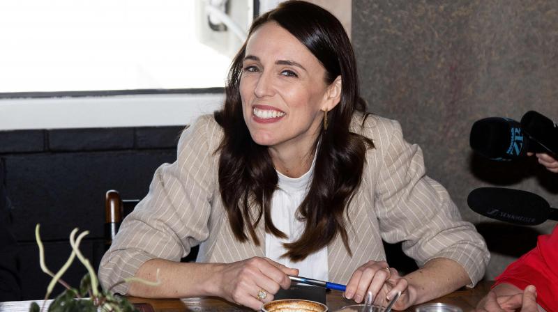 New Zealand Prime Minister Jacinda Ardern speaks with senior members of parliament a day after her landslide election win, in Auckland on October 18, 2020. (AFP)