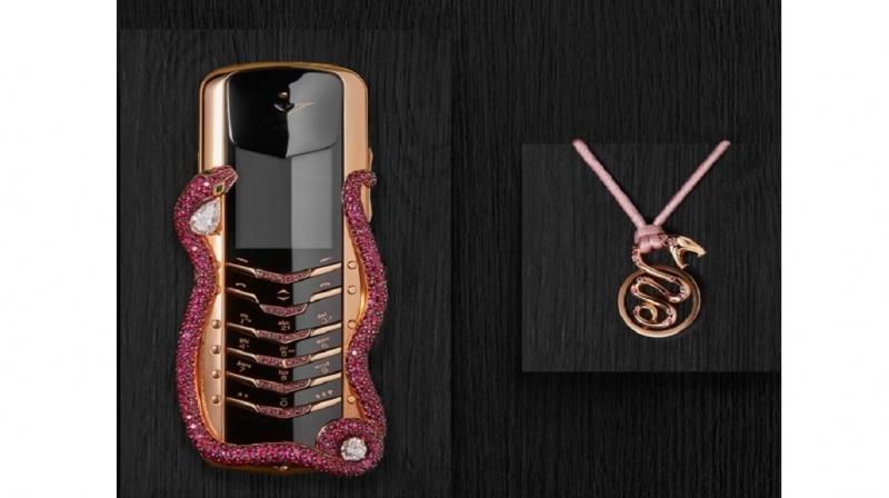 The highlighted feature of the phone is its design which includes a snake figure wrapped around the edges. The highlighted feature of the phone is its design which includes a snake figure wrapped around the edges.
