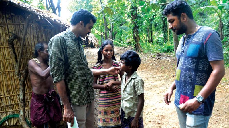 District Child Protection officer Subair and other NGO volunteers visit tribal huts in the Anakaal hamlet of Kottoor in Thiruvananthapuram to canvas drop-outs and other children who never went to school, for a summer vacation camp 'Agasthyante Poompattakal' organised by social justice department exclusively for tribal children at Podiyam on Saturday. (Photo: PEETHAMBARAN PAYYERI) District Child Protection officer Subair and other NGO volunteers visit tribal huts in the Anakaal hamlet of Kottoor in Thiruvananthapuram to canvas drop-outs and other children who never went to school, for a summer vacation camp 'Agasthyante Poompattakal' organised by social justice department exclusively for tribal children at Podiyam on Saturday. (Photo: PEETHAMBARAN PAYYERI)