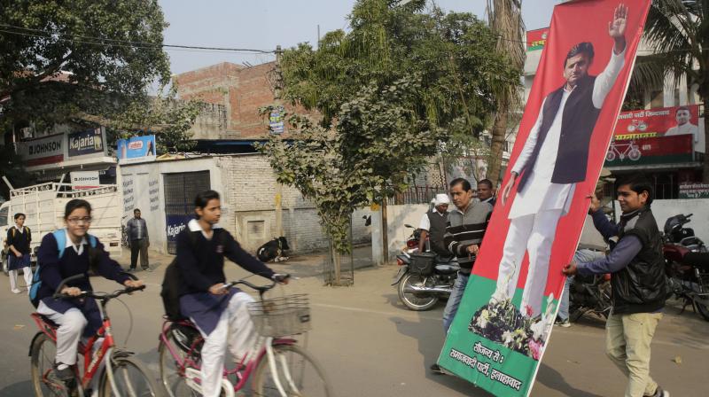 Samajwadi Party (SP) workers carry a billboard showing party leader and Chief Minister of Uttar Pradesh state Akhilesh Yadav in Allahabad. (Photo: PTI) Samajwadi Party (SP) workers carry a billboard showing party leader and Chief Minister of Uttar Pradesh state Akhilesh Yadav in Allahabad. (Photo: PTI)