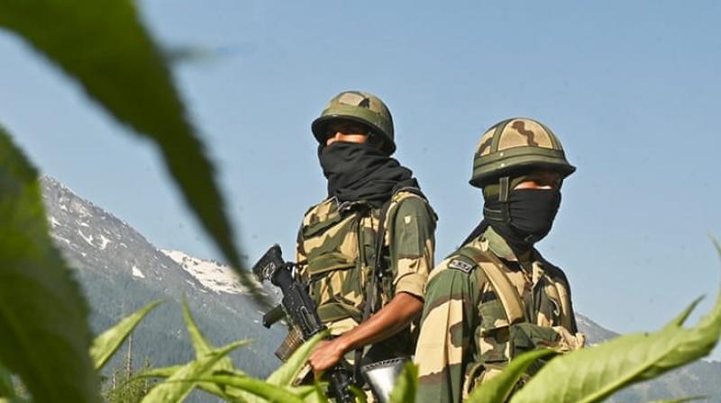 Indian Border Security Force (BSF) soldiers guard a highway leading towards Leh, bordering China, in Gagangir (AFP)