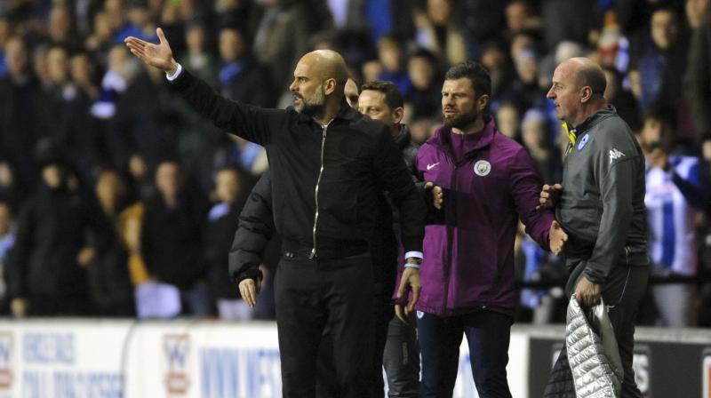 Pep Guardiola's quest to win an unprecedented quadruple with Manchester City came to a stunning and controversial end when they fell to a 1-0 defeat at third-tier Wigan in the fifth round of the FA Cup. (Photo: AP) Pep Guardiola's quest to win an unprecedented quadruple with Manchester City came to a stunning and controversial end when they fell to a 1-0 defeat at third-tier Wigan in the fifth round of the FA Cup. (Photo: AP)
