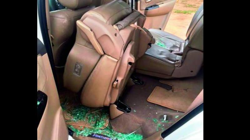 In this picture released by the AICC, broken glass piece are seen inside a car after alleged stone pelting at Congress vice-president Rahul Gandhi’s convoy during his visit to flood affected Dhanera village of Banaskantha district on Friday. (Photo: PTI) In this picture released by the AICC, broken glass piece are seen inside a car after alleged stone pelting at Congress vice-president Rahul Gandhi’s convoy during his visit to flood affected Dhanera village of Banaskantha district on Friday. (Photo: PTI)