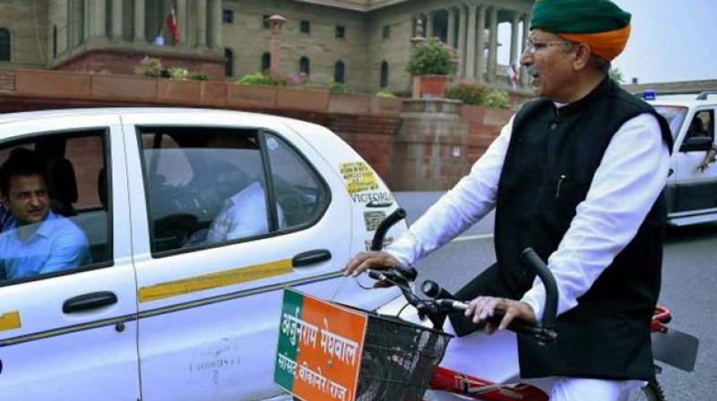 Arjun Ram Meghwal who is minister of state for finance riding a bicycle to Parliament. (Photo: File/PTI) Arjun Ram Meghwal who is minister of state for finance riding a bicycle to Parliament. (Photo: File/PTI)