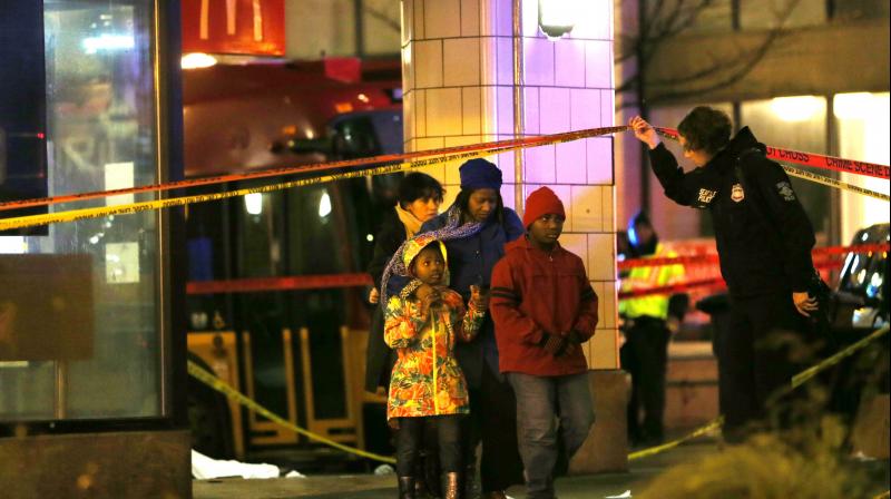 People are escorted by police away from the scene of a shooting at 3rd Avenue and Pine Street in the central business district of Seattle, Washington. AFP photo