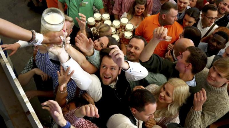 As the gates opened, many guests ran to the beer tents to make sure they’d catch one of the coveted spots on the long, wooden benches inside. (Photo: AP) As the gates opened, many guests ran to the beer tents to make sure they’d catch one of the coveted spots on the long, wooden benches inside. (Photo: AP)