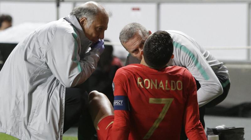 Cristiano Ronaldo receives treatment from medical staff during the Euro 2020 group B qualifying soccer match between Portugal and Serbia. (Photo: AP) Cristiano Ronaldo receives treatment from medical staff during the Euro 2020 group B qualifying soccer match between Portugal and Serbia. (Photo: AP)