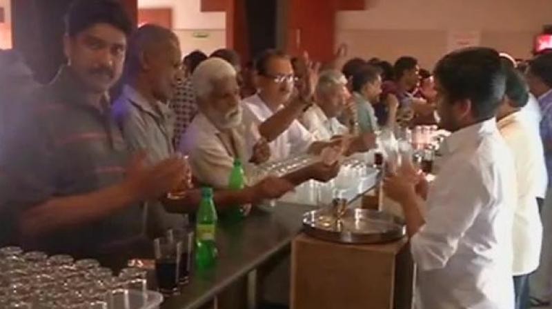 Overjoyed locals crowd the bars after LDF reopens 77 bars, in Kerala. (Photo: Twitter | ANI) Overjoyed locals crowd the bars after LDF reopens 77 bars, in Kerala. (Photo: Twitter | ANI)