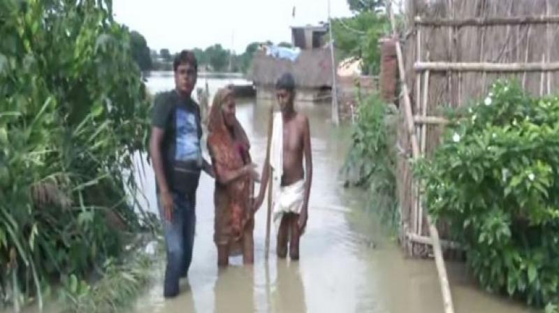 As many as 33 people have lost their lives due to the deluge, while approximately 26 lakh people in over 12 districts have been adversely affected by the calamity. (Photo: ANI) As many as 33 people have lost their lives due to the deluge, while approximately 26 lakh people in over 12 districts have been adversely affected by the calamity. (Photo: ANI)