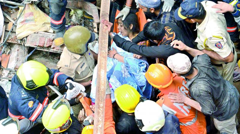 NDRF personnel carry out rescue operation at the collapse site of the four-storey Kesarbai building at Dongri in Mumbai, on Tuesday, which killed 11 people besides trapping 40 others. (Photo: DC) NDRF personnel carry out rescue operation at the collapse site of the four-storey Kesarbai building at Dongri in Mumbai, on Tuesday, which killed 11 people besides trapping 40 others. (Photo: DC)