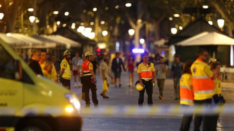 Emergency workers stand on a blocked street in Barcelona, Spain, Thursday. (Photo: AP) Emergency workers stand on a blocked street in Barcelona, Spain, Thursday. (Photo: AP)