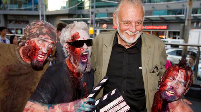 In this, Sept. 12, 2009, file photo, director George Romero poses with some fans dressed as zombies after accepting a special award during the Toronto International Film Festival in Toronto. (Photo: AP) In this, Sept. 12, 2009, file photo, director George Romero poses with some fans dressed as zombies after accepting a special award during the Toronto International Film Festival in Toronto. (Photo: AP)