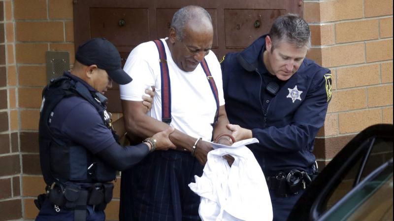 Bill Cosby is escorted out of the Montgomery County Correctional Facility. (Photo: AP) Bill Cosby is escorted out of the Montgomery County Correctional Facility. (Photo: AP)