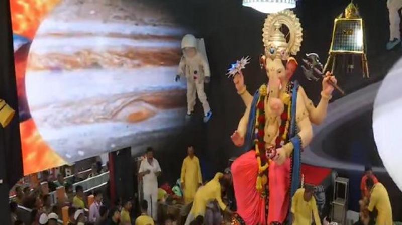 The approximately 20-feet high Ganapati idol at Lalbaug has been crafted in a traditional manner and is installed in a beautiful pandal decorated on the theme of ISRO's ambitious Chandrayaan-2 spacecraft which was launched in July. (Photo: ANI) The approximately 20-feet high Ganapati idol at Lalbaug has been crafted in a traditional manner and is installed in a beautiful pandal decorated on the theme of ISRO's ambitious Chandrayaan-2 spacecraft which was launched in July. (Photo: ANI)