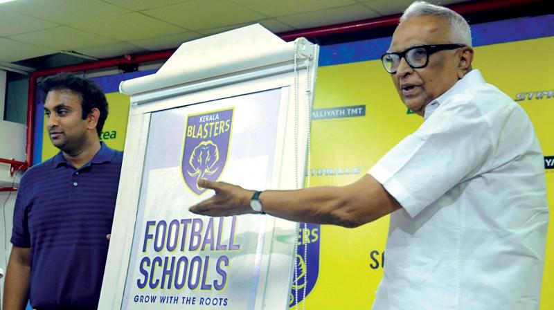 erala Football Association President KMI Mather points to the logo of Kerala Blasters Football Schools as the club CEO Varun Tripuraneni looks on, at the Jawaharlal Nehru Stadium in Kochi on Friday. (Photo: DC ) erala Football Association President KMI Mather points to the logo of Kerala Blasters Football Schools as the club CEO Varun Tripuraneni looks on, at the Jawaharlal Nehru Stadium in Kochi on Friday. (Photo: DC )