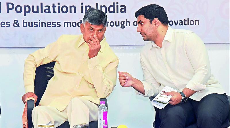 Chief Minister N. Chandrababu Naidu listens to IT minister N. Lokesh during Berkeley- Andhra Smart Village Open Innovation Forum at KL University on Thursday. Chief Minister N. Chandrababu Naidu listens to IT minister N. Lokesh during Berkeley- Andhra Smart Village Open Innovation Forum at KL University on Thursday.