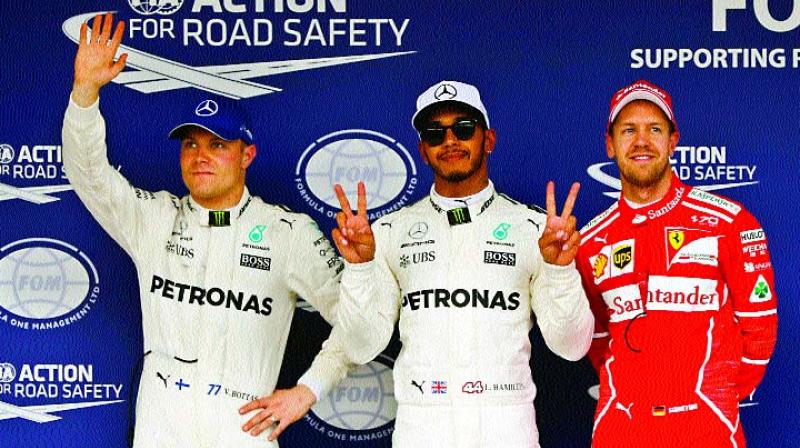 Lewis Hamilton (centre) poses with Valtteri Bottas (left) and Sebastian Vettel after getting pole position at Suzuka (Photo: AP) Lewis Hamilton (centre) poses with Valtteri Bottas (left) and Sebastian Vettel after getting pole position at Suzuka (Photo: AP)